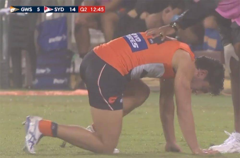 Taranto struggles to his feet after the heavy collision and is taken from the field. Photo: Fox