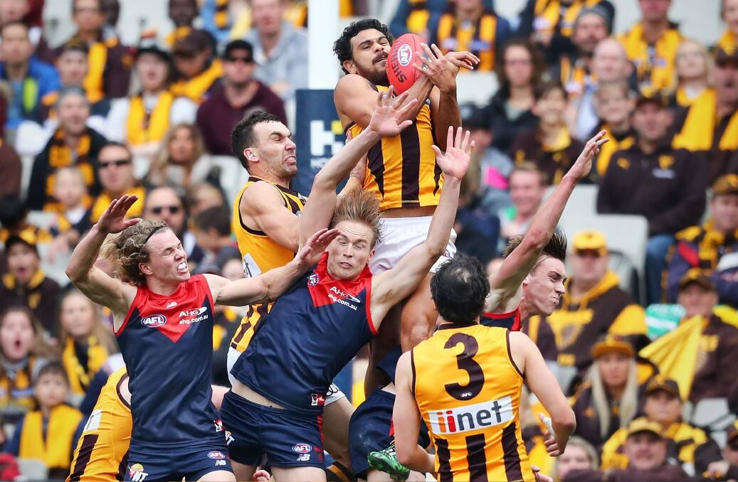 Cyril Rioli takes an exceptional pack mark for Hawthorn. Photo: Scott Barbour