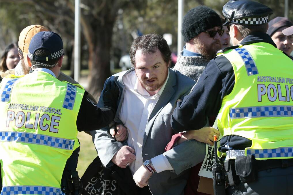 Police separate a counter-protestor from Reclaim Australia members at Sunday's rally. Photo: Jeffrey Chan