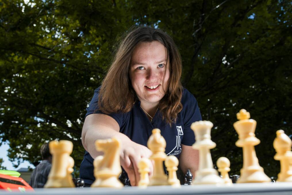 Alana Chibnall playing chess at the ACT Chess Association chess expo in Garema Place. Photo: Rohan Thomson