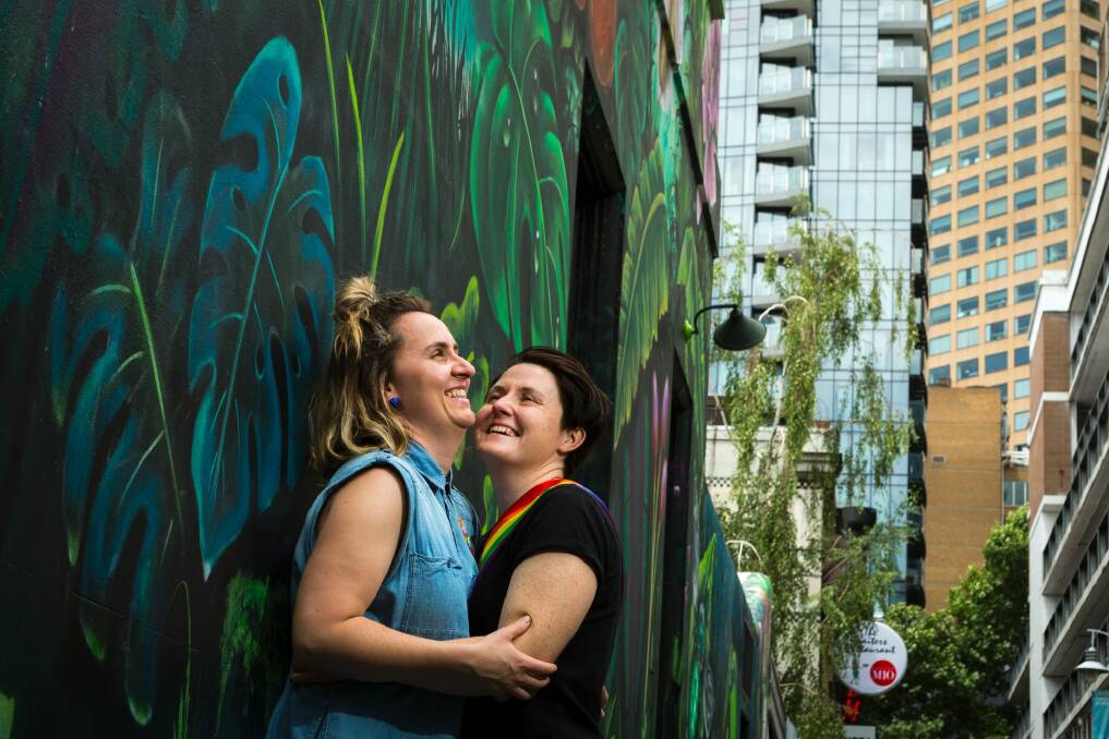 Zoe McDonald and Katie Larsen celebrate the vote at the State Library in Melbourne. Photo: Chris Hopkins