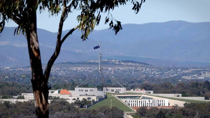 The flag at Parliament House, Canberra flew at half mast to honour the memorial for Nelson Mandela on Tuesday. Photo: Andrew Meares
