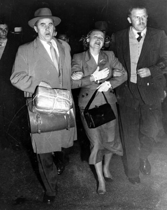 Two Soviet KGB agents ‘escort’ Evdokia Petrov across the tarmac at Sydney Airport in April 1954 . Photo: Supplied