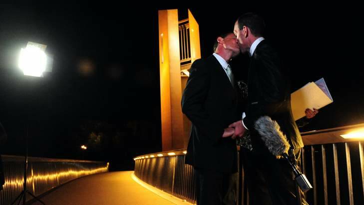 Alan Wright, left, and Joel Player celebrate becoming Australia's first same-sex married couple, at 12.01am on December 7 in Canberra. Photo: Karleen Minney