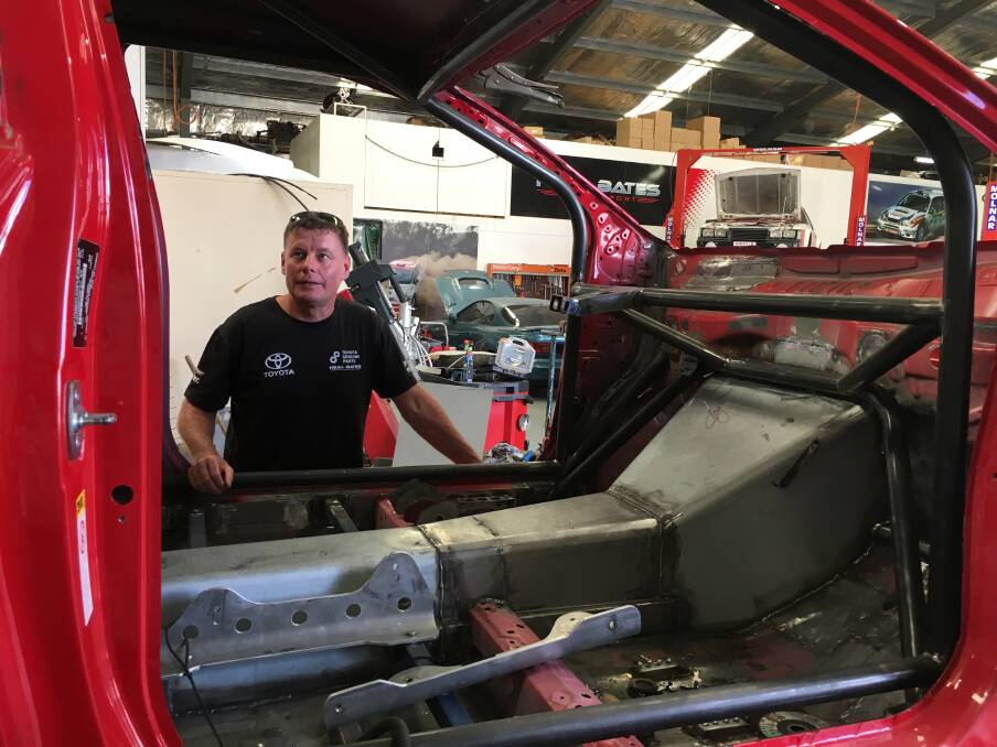 Canberra's Neal Bates looks over the team's Toyota Yaris rally car being built for the 2019 season. Photo: Peter Brewer