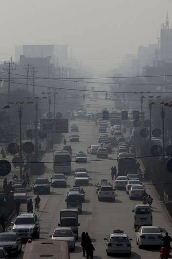 Traffic moves through a thick haze in Linfen, Shanxi province, China. Photo: Bloomberg