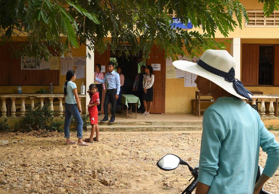 People arrive to cast their vote at Koktrob School in Kbal Seh village, in Kandal Province. Photo: Kate Geraghty