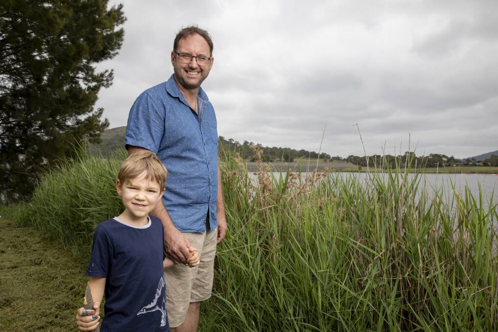 Ross Thompson, a University of Canberra researcher, is conducting ACT government-backed research at Lake Tuggeranong to determine why it gets frequent algae outbreaks. He is pictured here with his son Zac. Photo: Sitthixay Ditthavong