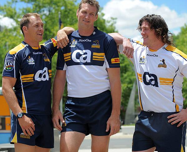 Stephen Hoiles, Justin Harrison and Guy Shepherdson model the new Brumbies jersey. Photo: Graham Tidy