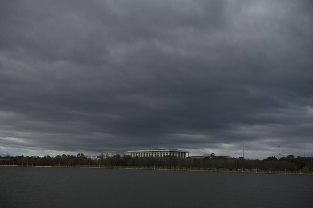 Dark clouds hang over Lake Burley Griffin before the rain hit on Sunday.