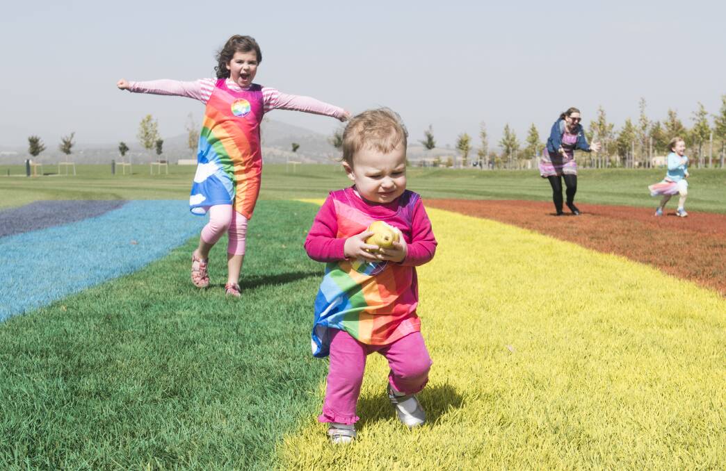Sophia, 6 and Aurelia Gibbons, 1 of Palmerston play on the giant rainbow. Photo: Elesa Kurtz
