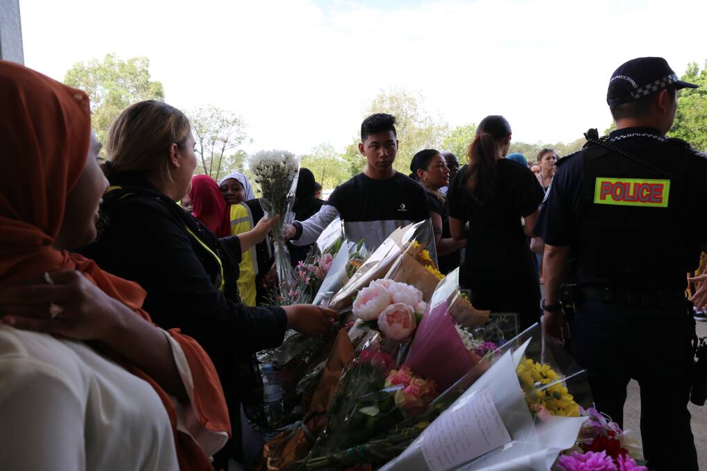 Flowers were handed at the door in show of support to the Muslim community. Photo: Jocelyn Garcia