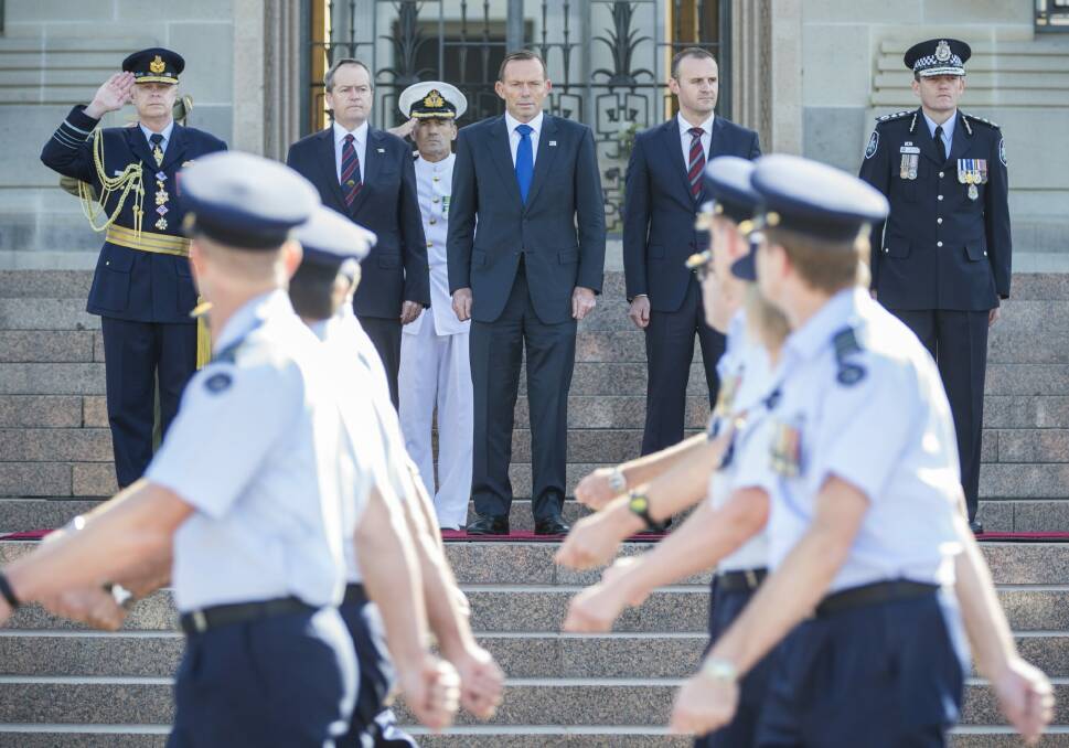 [L-R]: Chief of the Defence Force, Air Chief Marshal Mark Binskin, salutes as Opposition Leader Bill Shorten, Prime Minister Tony Abbott, ACT Chief Minister Andrew Barr and Australian Federal Police Commissioner Mark Colvin receive the parade on Saturday. 

 Photo: Matt Bedford