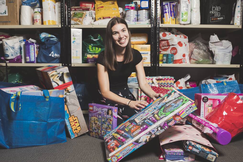 Fundraising and events officer at Anglicare ACT, Tatum Zotti,  is sorting through donations for their Christmas gift drive this year. Photo: Jamila Toderas