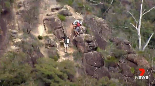 Bushwalkers being evacuated off Mount Beerwah after reports of isolated pockets of fire on the mountain.  Photo: 7 News/Twitter.