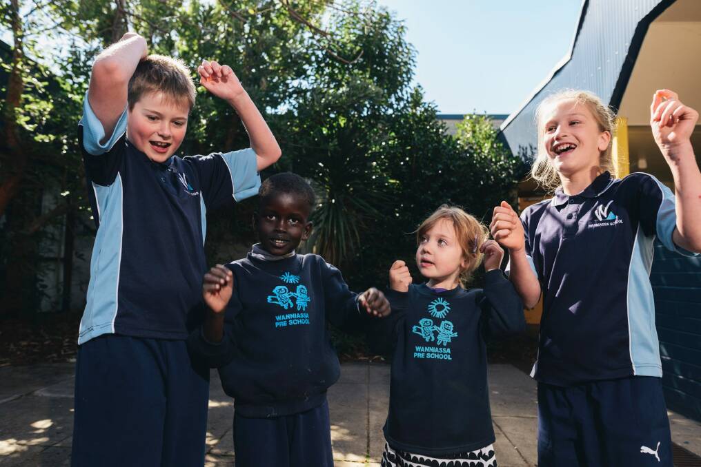Wanniassa School is celebrating its 40th birthday and a big fun day is planned for Sunday. Year 6 students Sam Crowther and Taylah Perrett with preschool students Deng Kuol and Shayla Lloyd. Photo: Rohan Thomson