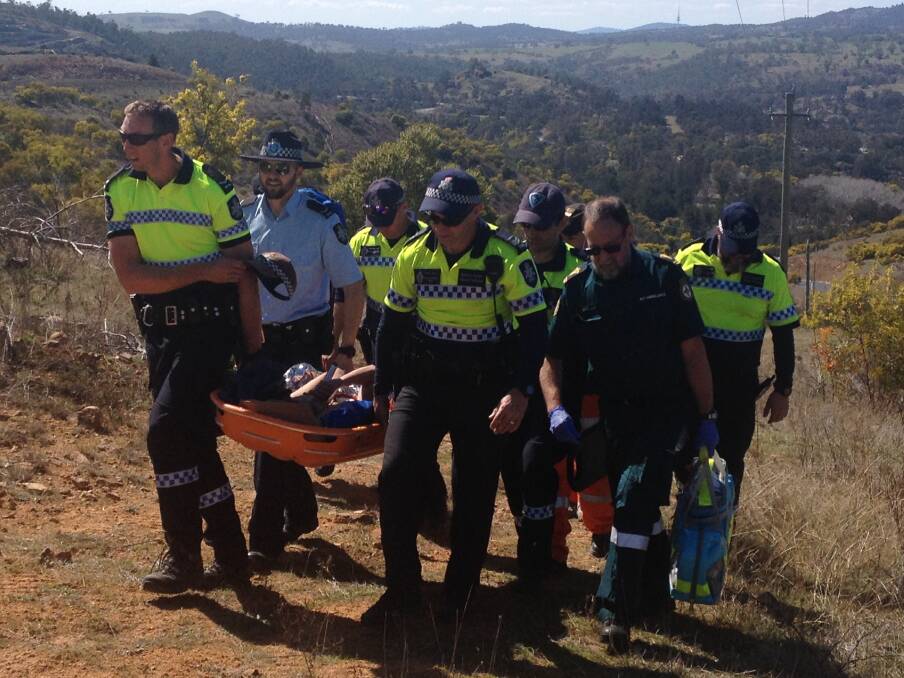 Emergency services help Kathleen Bautista to safety. She was found in a remote area of the Cotter near Canberra after seven days of being reported missing in 2015.  Photo: Supplied