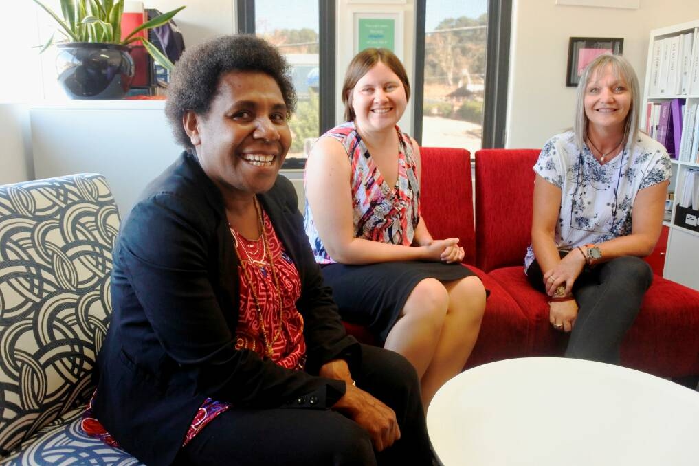 Femili?PNG casework manager Evan Biseo with Lindy Kanan and Domestic Violence Crisis Service director of crisis and legal Dearne Weaver. Photo: Georgina Connery