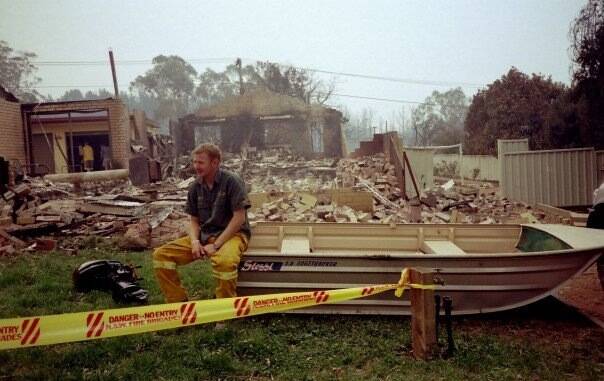 Mr Dutkiewicz at the scene of his house that was destroyed in the 2003 Canberra fires, picture taken by his mum, Carol Dutkiewicz. Photo: Supplied