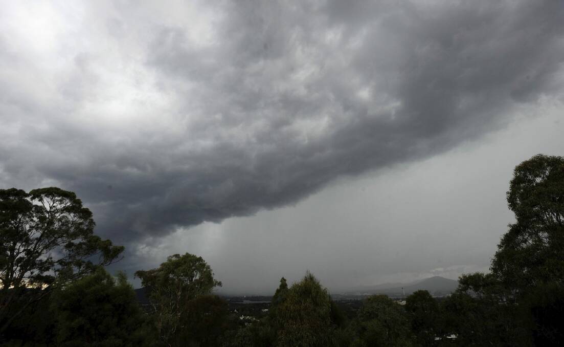 An afternoon storm rolls into Canberra, seen from Red Hill lookout.  Photo: Graham Tidy