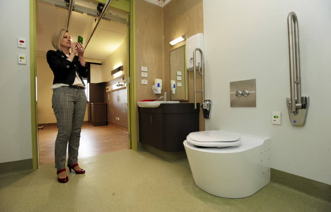 Chief Minister Katy Gallagher visits the refurbished wards. The toilet is capable of supporting
500kg. Photo: Graham Tidy