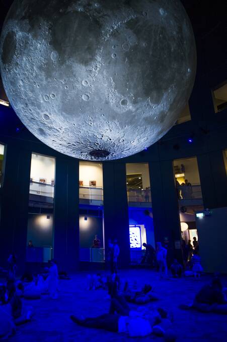 Visitors took a moment to lounge beneath the new moon exhibit. Photo: Elesa Kurtz