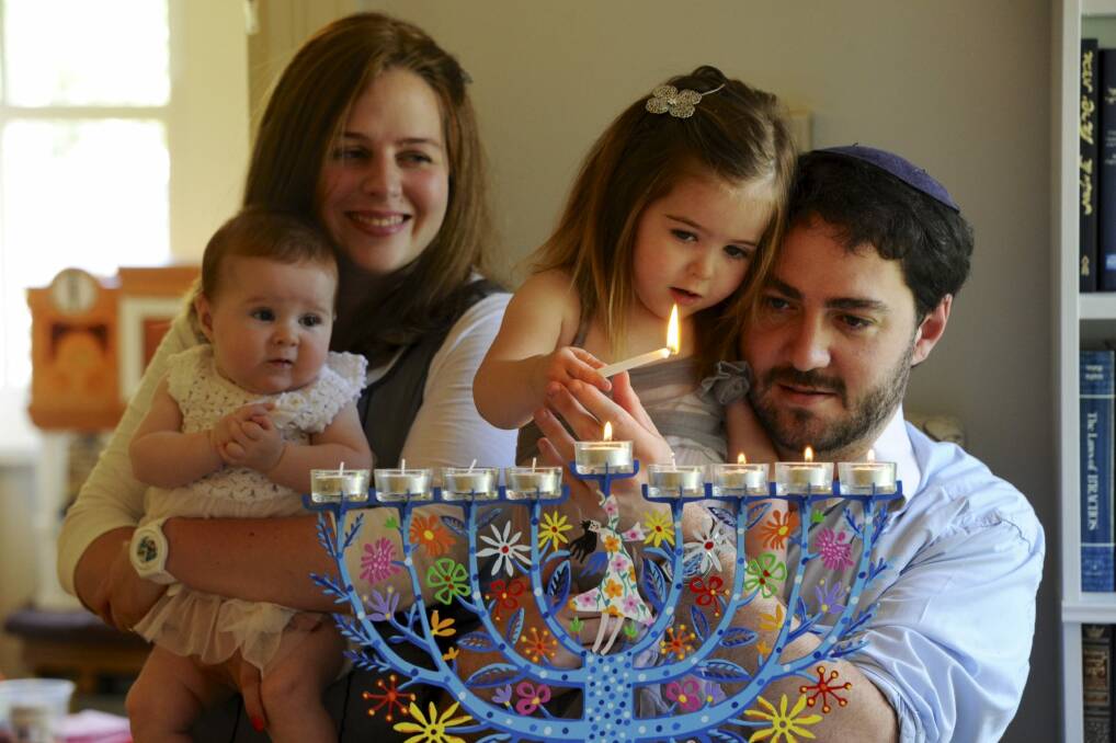 Happy Hannukah: Rabbi Alon Meltzer, his wife Linsay and their two daughters celebrate Hanukkah at their home in Barton.  Photo: Graham Tidy