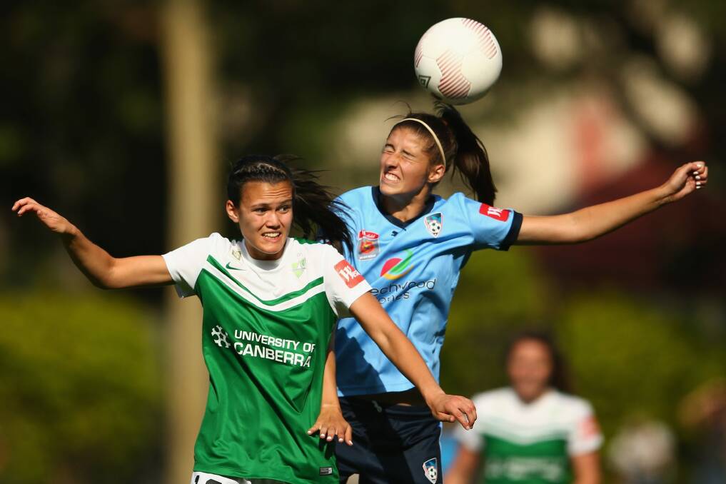 Canberra United defender Rebecca Kiting, left, puts pressure on Sydney FC's Amy Harrison during their 1-0 win earlier this season. Photo: Mark Kolbe