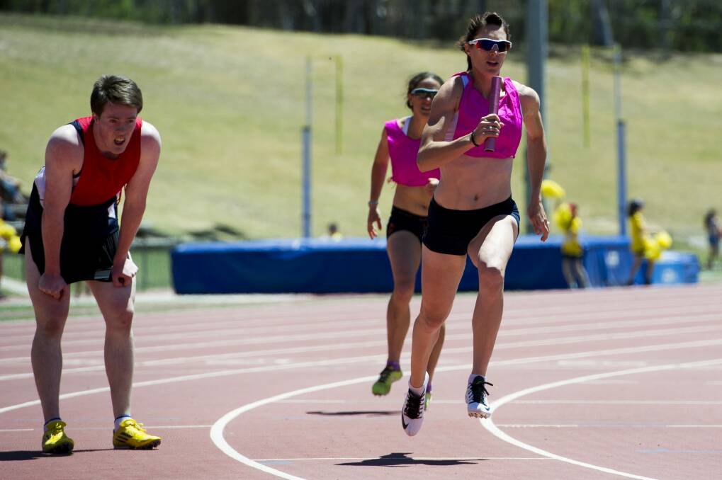 Lauren Wells runs the first seniors 4x400m relay event held at the AIS Athletics track during the Little Athletics event on Sunday. Photo: Jay Cronan