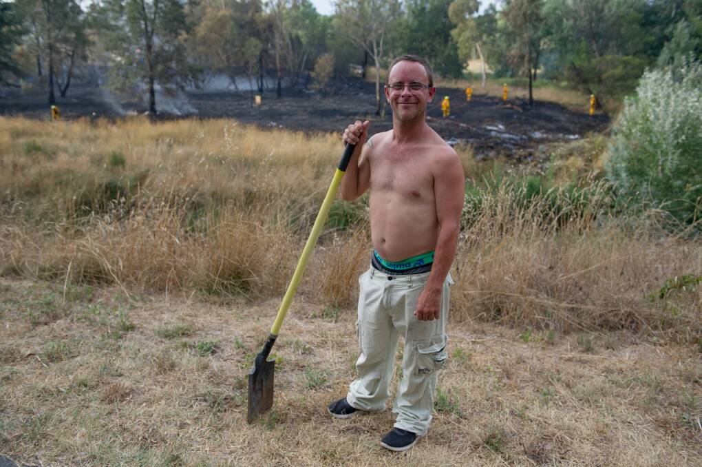 Resident Nick Hart ready to fight the fires as Emergency services attend a small grass fire in Umbagong District Park in Latham.  Photo: Jay Cronan