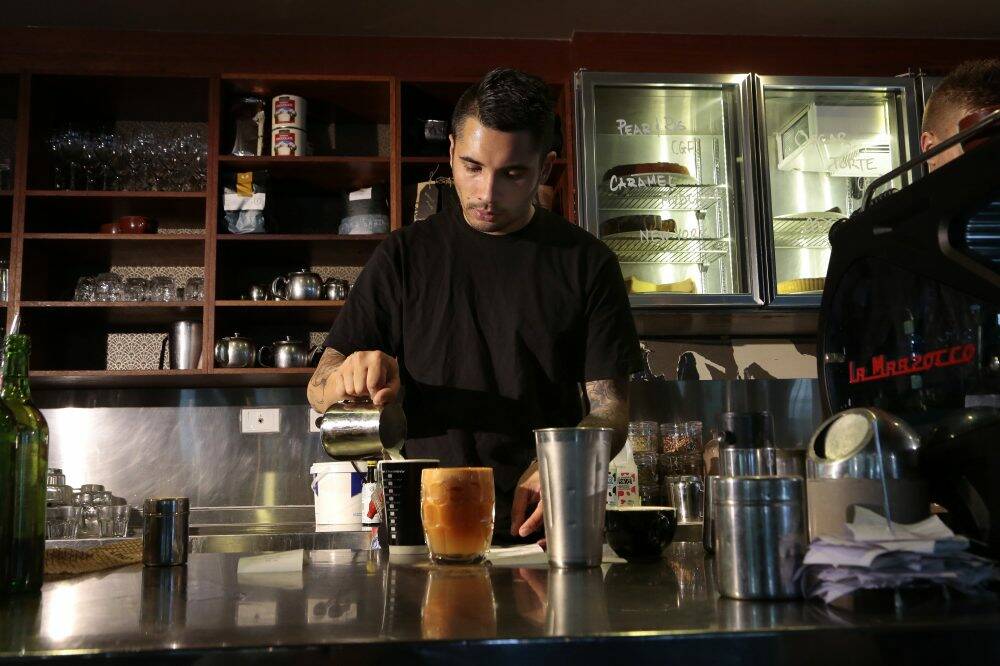 Jamie Morris behind the counter at Gus' Cafe in Civic. Photo: Jeffrey Chan