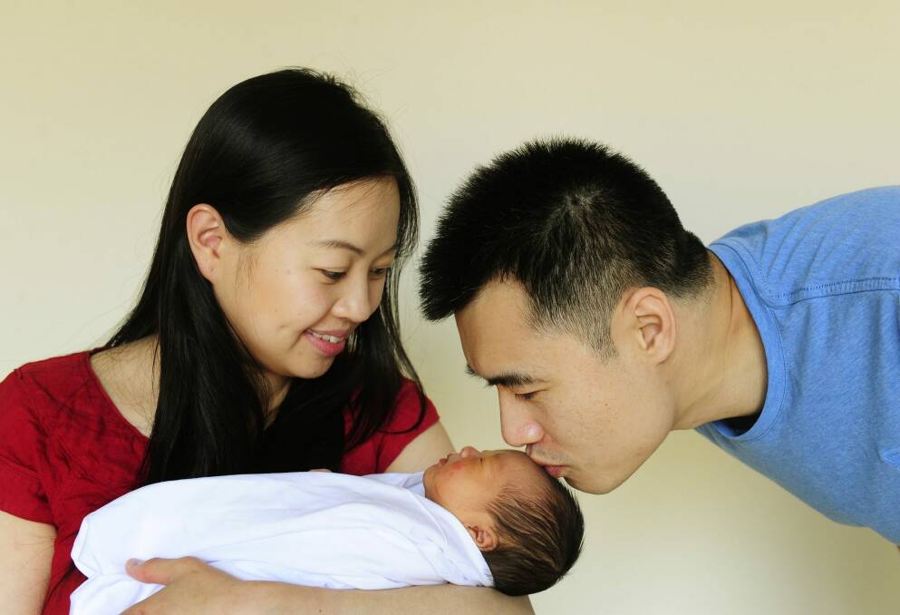 Liz and Colin Cheong, of Gungahlin, with their daughter Chelsea, who was born in a hurry on the side of the Gungahlin Drive Extension on Friday.  Photo: Melissa Adams