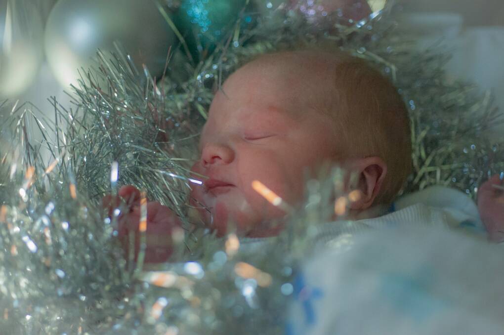 Canberra's first Christmas baby was born after a three-day labour to parents Stella Vongdara and Alex Pabian at the Canberra hospital.  Photo: Karleen Minney