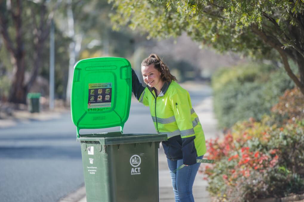 Envirocom environment education officer Kathryn Sullivan inspecting green waste bins in Kambah. Green waste bins are being randomly inspected to see who is or who isn't doing the right thing . Photo: Karleen Minney
