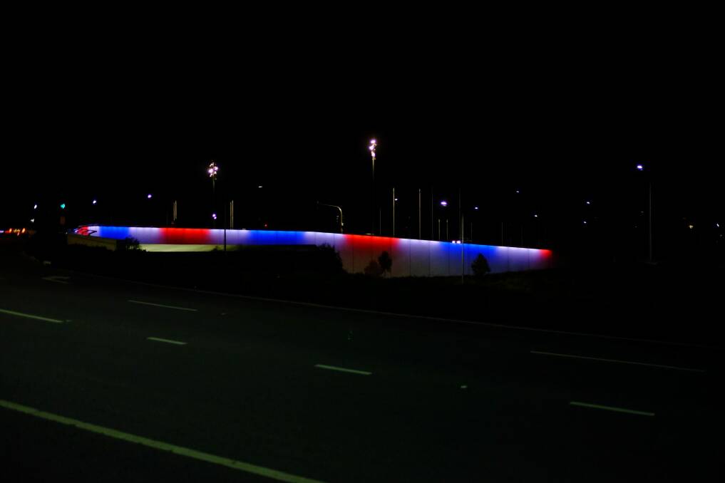 The Kings Avenue bridge in Canberra lit up in the colours of the French flag. Photo: Dimitri Tolleter