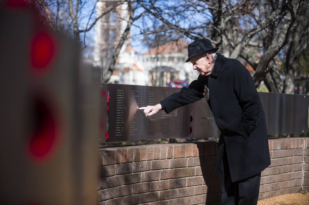 First ever national Australian Jewish War Memorial at the ACT Jewish Community Centre. Jules Hoffman points to his brother's name. Photo: Dion Georgopoulos