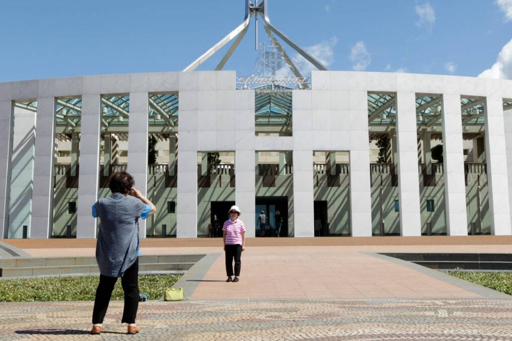 Tourists on the forecourt of Parliament House in Canberra. Photo: Alex Ellinghausen