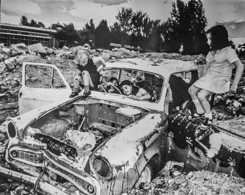 Children playing in a burnt out car next to the Forrest Primary school in a photo from 1975.