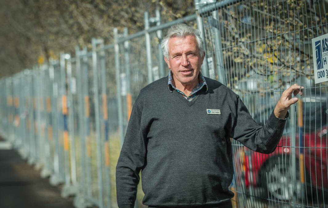 Mother Teresa Catholic Primary School principal Peter Hughes in the school car park, where garden beds have been fenced off after the discovery of asbestos. Photo: Karleen Minney