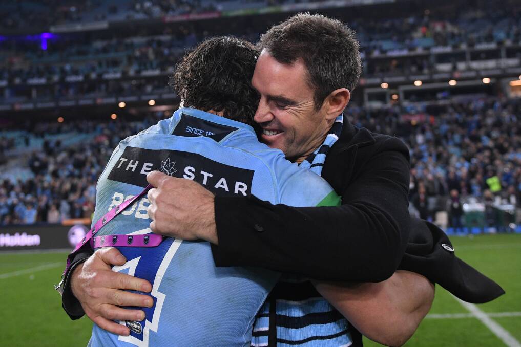 NSW Blues coach Brad Fittler (right) celebrates with James Roberts during Game 2 of the 2018 State of Origin series between the NSW Blues and the Queensland Maroons at ANZ Stadium in Sydney, Sunday, June 24, 2018. Photo: AAP