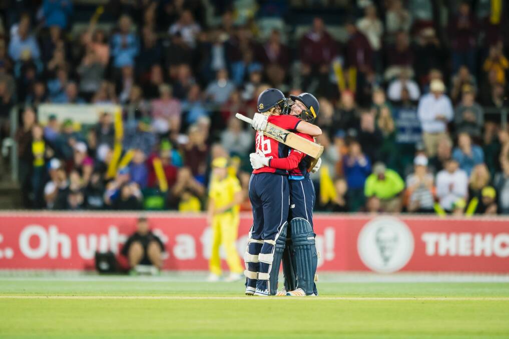 England's Katherine Brunt embraces Danielle Wyatt after Wyatt scored a century in the third T20 match at Manuka oval on Tuesday. Photo: Sitthixay Ditthavong Photo: Sitthixay Ditthavong