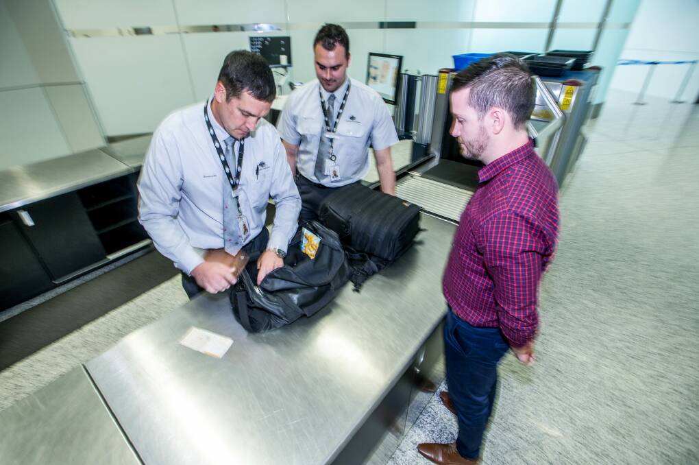 Biosecurity officers Osorio and Chris at the luggage check point.  Photo: Karleen Minney
