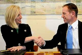 ACT Chief Minister Katy Gallagher and Shane Rattenbury all smiles after putting pen to paper and signing an agreement to form government in 2012. Picture: Colleen Petch