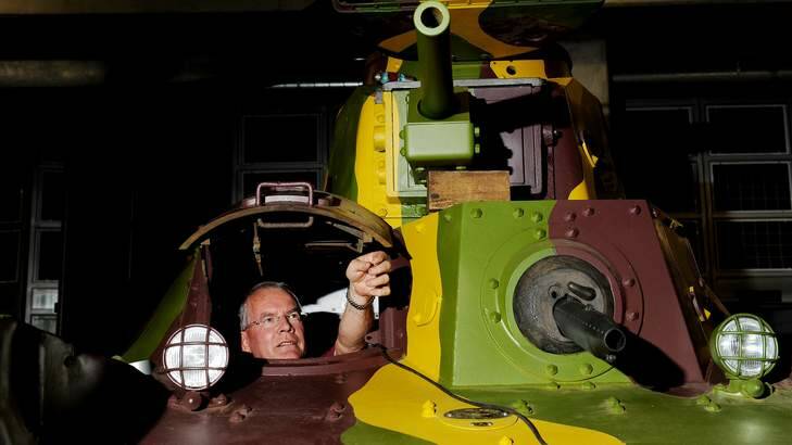 Australian War Memorial restorer John Kemister sits inside  a Japanese Type 95 Ha-Go tank in the AWM annex. Photo: Colleen Petch