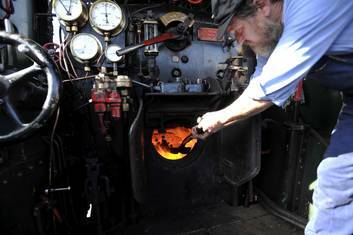 Train driver (with a sideline in information technology systems analysis) Peter Anderson on the footplate of the Australian Railway Historical Society's 109-year-old locomotive, 3016. Photo: Jay Cronan