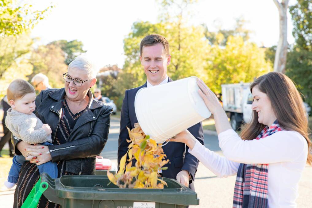 ACT Labor parliamentarian Bec Cody, left, City Services Minister Chris Steel, centre, with Farrer resident Greer Garrett-Meehan, who received her first green-waste collection in Farrer on Monday.  Baby Freddie Garrett-Meehan looks on. Photo: Supplied
