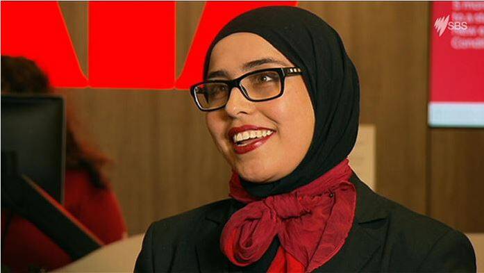 From next year Westpac bank teller Manija Akbari will wear a new corporate hijab to work. Photo: SBS News