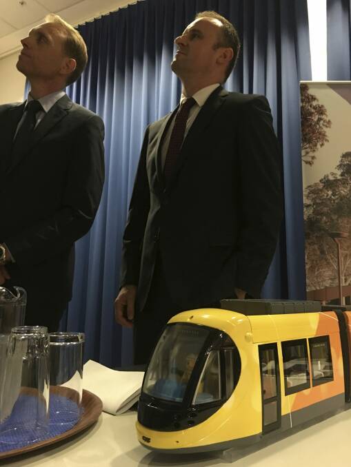 Simon Corbell, left, and Andrew Barr announcing the winning bidder for the Canberra tram, with a model of the Spanish-made trams.  Photo: Kirsten Lawson