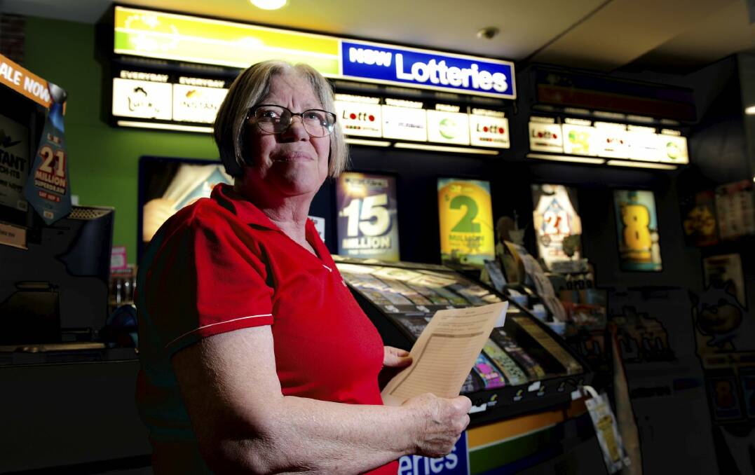 Narelle Dixon with the newsagencies petition against the sale of Lotto products in
Woolworths petrol stations. Photo: Graham Tidy