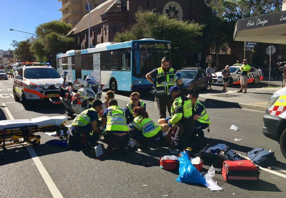 Paramedics attend to Bill Springett-Kelly after his motorbike collision last year in Bondi. Photo: NSW Ambulance